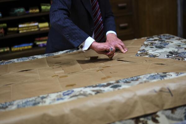 A tailor works at the Gammarelli ecclesiastic clothes tailor shop in Rome, Wednesday, April 30, 2025. (AP Photo/Francisco Seco)