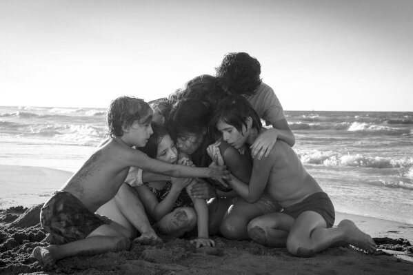 
              This image released by Netflix shows Yalitza Aparicio, center, in a scene from the film "Roma," by filmmaker Alfonso Cuaron. The film is nominated for an Oscar for both best foreign language film and best picture. The 91st Academy Awards will be held on Sunday. (Carlos Somonte/Netflix via AP)
            