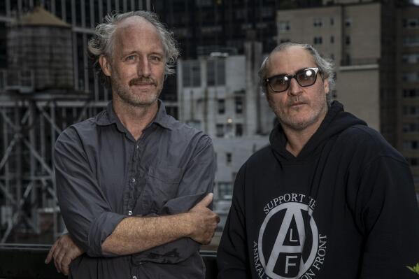 Director Mike Mills, left, and actor Joaquin Phoenix pose for a portrait to promote their film "C'mon C'mon" on Monday, Oct. 4, 2021, in New York. (Photo by Andy Kropa/Invision/AP)