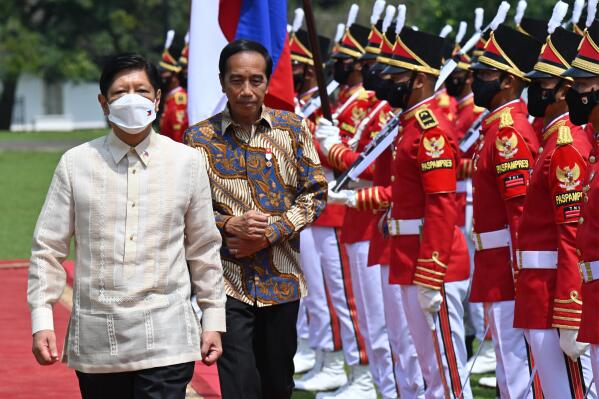 Philippine President Ferdinand Marcos Jr., left, escorted by Indonesian President Joko Widodo inspects an honor guard upon his arrival at the Presidential Palace in Bogor, West Java, Indonesia, Monday, Sept, 5, 2022. (Adek Berry/ Pool Photo via AP)