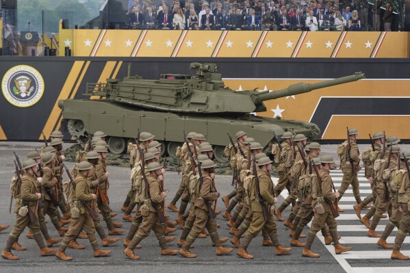 Soldiers from the Army 82nd Airborne Division, dressed in World War I era uniforms, march past the reviewing stand and President Donald Trump during a military parade commemorating the Army's 250th anniversary, coinciding with his 79th birthday, Saturday, June 14, 2025, in Washington. (AP Photo/Julia Demaree Nikhinson)