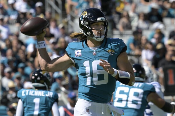 Jacksonville Jaguars quarterback Trevor Lawrence (16) looks to pass against the Indianapolis Colts during the first half of an NFL football game, Sunday, Oct. 15, 2023, in Jacksonville, Fla. (AP Photo/Phelan M. Ebenhack)