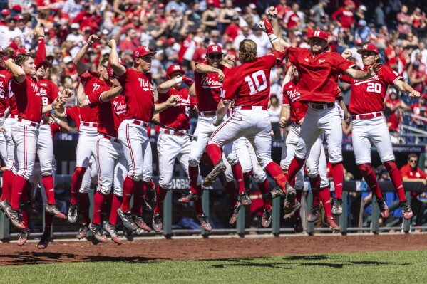 Nebraska players celebrate after a home run by teammate Ben Columbus (10) during the fifth inning of a game against Ohio State in the Big Ten NCAA college baseball tournament in Omaha, Neb., Friday, May 24, 2024. (Chris Machian/Omaha World-Herald via AP)