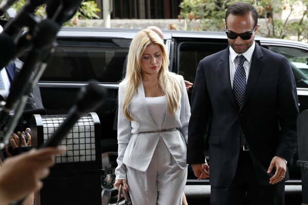 
              Former Donald Trump presidential campaign foreign policy adviser George Papadopoulos, right, who pleaded guilty to one count of making false statements to the FBI during the agency's Russia probe, holds hands with his wife Simona Mangiante, as they arrive at federal court for sentencing, Friday, Sept. 7, 2018, in Washington. (AP Photo/Jacquelyn Martin)
            
