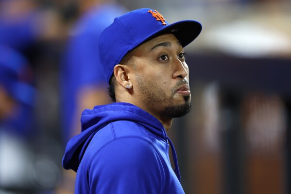 New York Mets Edwin Diaz looks out from the dugout during the seventh inning of a baseball game against the Miami Marlins, Tuesday, June 11, 2024, in New York. (AP Photo/Noah K. Murray)