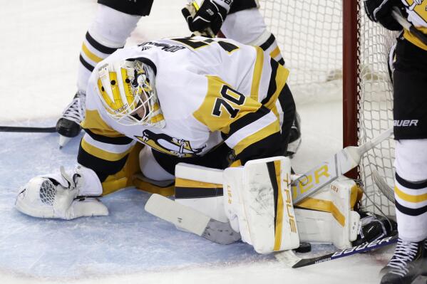 Pittsburgh Penguins goaltender Louis Domingue makes a save against the New York Rangers during the second overtime of Game 1 of an NHL hockey Stanley Cup first-round playoff series Tuesday, May 3, 2022, in New York. (AP Photo/Adam Hunger)
