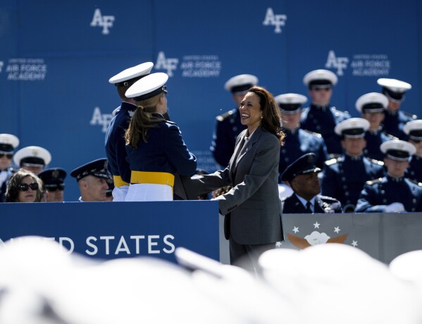 Vice President of the United States Kamala Harris accepts a gift from the class of 2024 at the United States Air Force Academy graduation at Falcon Stadium on Thursday, May 30, 2024, in Colorado Springs, Colo. (Parker Seibold/The Gazette via AP)