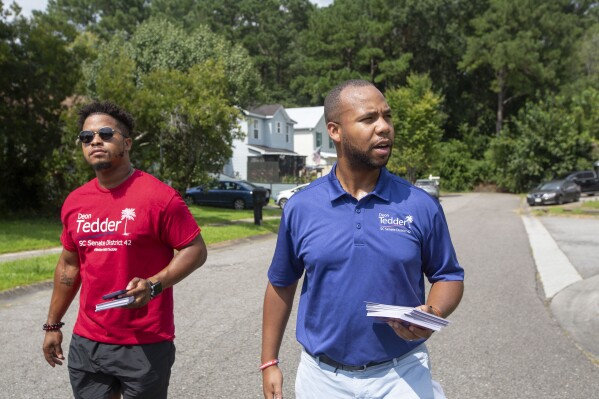 State Rep. Deon Tedder, D-North Charleston, right, canvasses with his team for the District 42 election in North Charleston, SC, on Saturday, Aug. 26, 2023. Tedder has won the Democratic nomination for an open South Carolina Senate seat by 11 votes, Thursday, Sept. 22. The South Carolina Election Commission certified the runoff results after a recount and the review of 10 disputed ballots. (Daniel Sarch/The Post And Courier via AP)