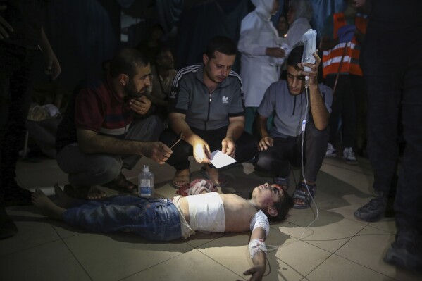 An injured Palestinian girl is treated at Al-Aqsa Martyrs Hospital in Deir al Balah, Gaza Strip, Friday, June 14, 2024. An Israeli airstrike on a home in the central city in the Gaza Strip killed two people and wounded several others including children, hospital officials said. (AP Photo/Mohammad Hajjar)