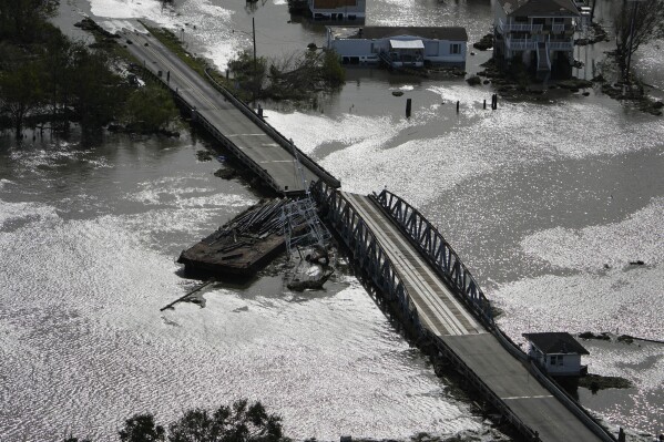 FILE - A barge damages a bridge that divides Lafitte, La., and Jean Lafitte, in the aftermath of Hurricane Ida, Aug. 30, 2021, in Lafitte, La. (AP Photo/David J. Phillip, File)