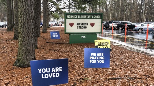 FILE - Signs stand outside Richneck Elementary School in Newport News, Va., Jan. 25, 2023. The first-grade teacher who was shot by her 6-year-old student at the Virginia school has resigned from her position, school officials said Tuesday, June 13, more than two months after she sued the district for $40 million. (AP Photo/Denise Lavoie, File)
