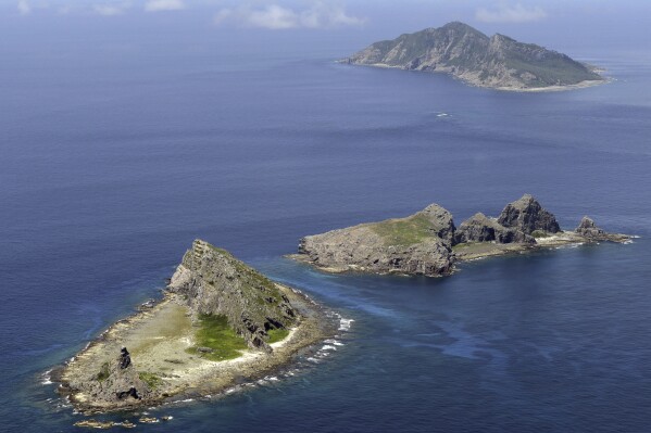 FILE - An aerial view of the tiny islands in the East China Sea, called Senkaku in Japanese and Diaoyu in Chinese are seen in Sept. 2012. Chinese coast guard vessels have been passing by Japanese-claimed waters for weeks in the East China Sea and China's warships have been edging near Japan's southwestern islands in recent days, Japanese officials said Thursday, Feb. 8, 2024. A fleet of four Chinese coast guard vessels on Thursday passed just outside of the territorial waters of Japan-controlled islands, which Beijing also claims, for the 49th day in a row, the Japanese Coast Guard said. (AP Photo/Kyodo News, File)