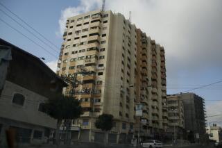 A view showing damage to the Al-Andalus tower in north Gaza City, which was hit by multiple Israeli airstrikes, Thursday, May 20, 2021. (AP Photo/Hatem Moussa)