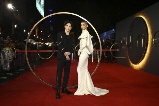 FILE - Timothee Chalamet, left, and Zendaya pose for photographers upon arrival at the premiere of the film "Dune," Oct. 18, 2021, in London. The release of “Dune: Part Two,” one of the fall's most anticipated releases, has been postponed from November 2023 until next near, Warner Bros. confirmed Thursday, Aug. 24, 2023. (Photo by Joel C Ryan/Invision/AP, File)
