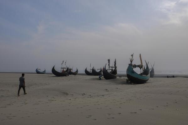 Fishing boats sit on a beach in Teknaf, Bangladesh, on March 9, 2023. On Dec. 1, 2022, around 180 Rohingya refugees fled from this beach, hoping to escape escalating violence in Bangladesh's Rohingya refugee camps. Their boat, which was bound for Indonesia, vanished a week into its journey. (AP Photo/Mahmud Hossain Opu)