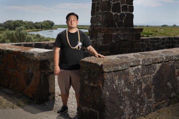 Minidoka Pilgrimage co-chair Stephen Kitajo, 34, whose grandparents were incarcerated at Minidoka, poses for a portrait at the remains of the historic reception building near the entrance to Minidoka National Historic Site, Saturday, July 9, 2023, in Jerome, Idaho. Kitajo says he never got to speak with his grandparents about their experience, but being involved in the pilgrimage has given him an opportunity to connect with the community and learn stories of those like his grandparents. "I've met so many people over the years of all ages, all backgrounds...But at the same time, we have so much in common." (AP Photo/Lindsey Wasson)