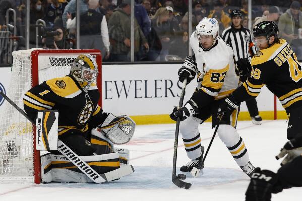 Pittsburgh Penguins' Mario Lemieux skates around the ice holding