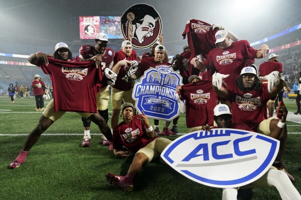 FILE - Florida State players pose after defeating Louisville in the Atlantic Coast Conference championship NCAA college football game Saturday, Dec. 2, 2023, in Charlotte, N.C. Florida State announced it will hold a Board of Trustees meeting on Friday, Dec. 22, and a person with knowledge of the situation told The Associated Press the future of the athletic department and its affiliation with the Atlantic Coast Conference will be discussed.(AP Photo/Erik Verduzco, File)
