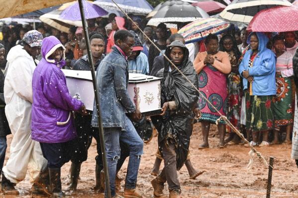 Pallbearers carry a coffin at the burial ceremony for some of the people who lost their lives following heavy rains caused by Cyclone Freddy in Blantyre, southern Malawi, Wednesday, March 15, 2023. After barreling through Mozambique and Malawi since late last week and killing hundreds and displacing thousands more, the cyclone is set to move away from land bringing some relief to regions who have been ravaged by torrential rain and powerful winds. AP Photo/Thoko Chikondi)