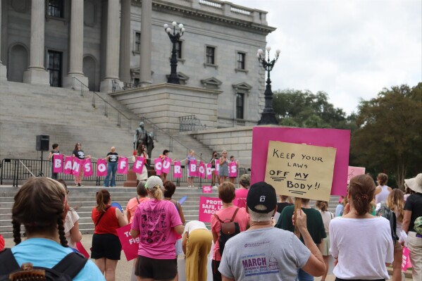 Protesters gather outside the state house in opposition to a proposed abortion ban debated, Aug. 30, 2022 by the South Carolina House of Representatives in Columbia, S.C. (AP Photo/James Pollard)