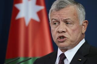 FILE - Jordan's King Abdullah II ibn Al-Hussein speaks at a news conference after talks at the Chancellery, in Berlin, Germany, March 15, 2022. Digital-rights researchers have concluded that the mobile phones of four Jordanian human rights activists were hacked over a two-year period with software made by the Israeli spyware company NSO Group. Tuesday, April 5, 2022 findings by Front Line Defenders and Citizen Lab said at least some of the hackings appear to have been carried out by the Jordanian government.(Hannibal Hanschke/Pool via AP, File)