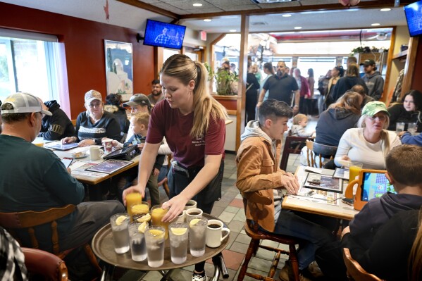 FILE - Waitress Rachel Gurcik serves customers at the Gateway Diner in Westville, Pa. on Oct. 22, 2023. On Friday, April 5, 2024, the U.S. government issues its March jobs report. (Tom Gralish/The Philadelphia Inquirer via AP, File)