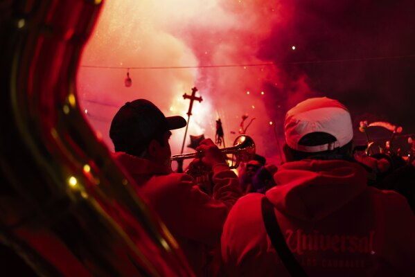 Musicians perform during a Muerteada parade in San Jose, Mexico, Thursday, Nov. 2, 2023. Mexicans in the Oaxacan town celebrate the traditional Muerteada, a theatrical recreation that is performed through the night of November 1 until the early morning of the following day, with dances and music parading through the streets, while telling the story of how a deceased person is resurrected with the help of a priest, a doctor and a spiritist. (AP Photo/Maria Alferez)