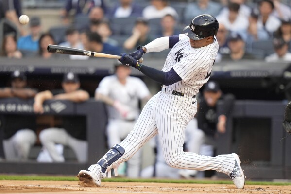 New York Yankees' Juan Soto hits a single against the Minnesota Twins during the first inning of a baseball game Wednesday, June 5, 2024, in New York. (AP Photo/Frank Franklin II)