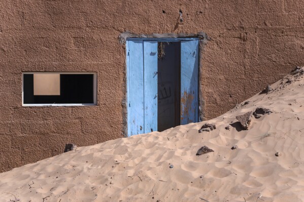 An abandoned house sits in sand near Chinguetti, Mauritania on Jan. 13, 2025. (AP Photo/Khaled Moulay)