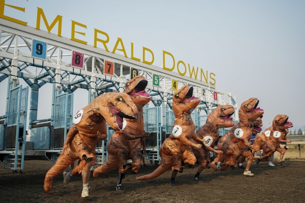 Racers, including eventual winner Ocean Kim (5), leave the gates for the championship race during the "T-Rex World Championship Races" at Emerald Downs, Sunday, Aug. 20, 2023, in Auburn, Wash. (AP Photo/Lindsey Wasson)