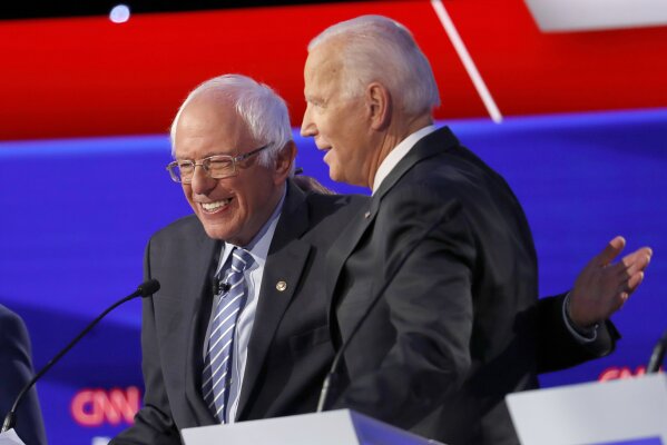 Democratic presidential candidate Sen. Bernie Sanders, I-Vt., left, and former Vice President Joe Biden hug during a Democratic presidential primary debate hosted by CNN/New York Times at Otterbein University, Tuesday, Oct. 15, 2019, in Westerville, Ohio. (AP Photo/John Minchillo)