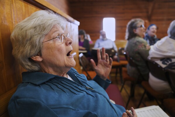 Chris Wilhelm of Black Mountain, N.C., participates in a Sacred Harp singing at Holly Springs Primitive Baptist Church in Bremen, Ga., on Saturday, March 22, 2025. (AP Photo/Jessie Wardarski)