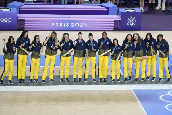 Players of Brazil show their bronze medals on the podium during the medals ceremony at the 2024 Summer Olympics, Sunday, Aug. 11, 2024, in Paris, France. (AP Photo/Dolores Ochoa)