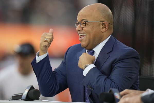 FILE -NBC broadcaster Mike Tirico motions to fans before the NFL Super Bowl 56 football game between the Los Angeles Rams and the Cincinnati Bengals, Sunday, Feb. 13, 2022, in Inglewood, Calif. Tirico and Dan Hicks will be sharing play-by-play duties at the U.S. Open golf championship this year. (AP Photo/Lynne Sladky, File)