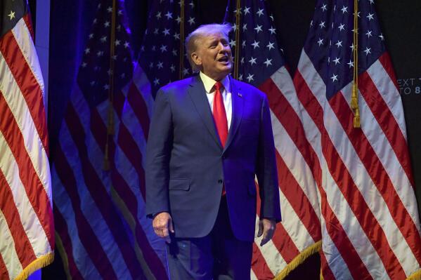 Former President Donald Trump takes the stage to speak at a campaign event Monday, March 13, 2023, in Davenport, Iowa. (AP Photo/Ron Johnson)