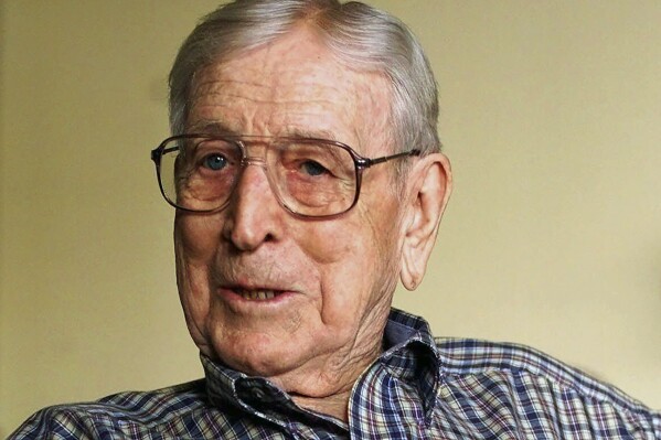 FILE - UCLA legendary basketball coach John Wooden pauses for a photo Tuesday, Sept. 26, 2000, at his Encino, Calif., home. John Wooden took UCLA to unprecedented heights that may never be reached again. (AP Photo/Damian Dovarganes, File)