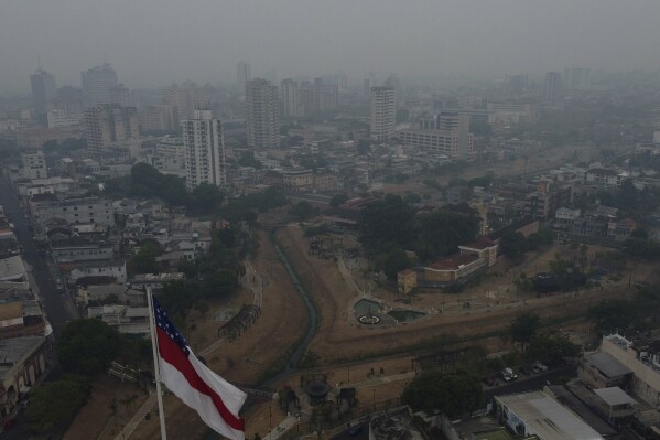 Smoke from wildfires fills the air during a drought in Manaus, Amazonas state, Brazil, Thursday, Oct. 12, 2023. In Manaus, a city of 2 million, air quality ranked among the worst globally, leading to the suspension of college classes and the cancellation of various activities, including an international marathon. (AP Photo/Edmar Barros)