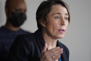 FILE - In this April 1, 2021 file photo, Mass. Attorney General Maura Healey, right, responds to questions from reporters as U.S. Rep. Ayanna Pressley, D-Mass., left, looks on during a news conference in Boston. Healey says Purdue Pharma's plan to settle thousands of lawsuits over the U.S. opioid epidemic doesn’t go far enough to hold members of the Sackler family accountable for the crisis. It would preserve the vast majority of the wealth held by the family members who own the company that makes OxyContin. (AP Photo/Steven Senne)