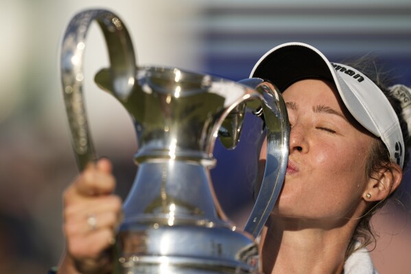 Nelly Korda kisses the trophy after winning the Chevron Championship LPGA golf tournament Sunday, April 21, 2024, at The Club at Carlton Woods in The Woodlands, Texas. (AP Photo/Eric Gay)
