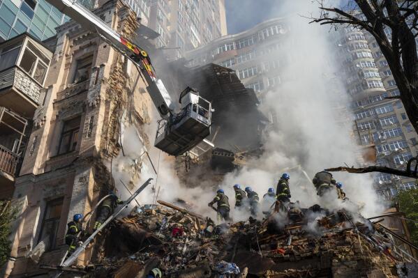 FILE - Firefighters work after a drone attack on buildings in Kyiv, Ukraine, on  Oct. 17, 2022. The Iranian-made drones that Russia sent slamming into central Kyiv this week have produced hand-wringing and consternation in Israel, complicating the country’s balancing act between Russia and the West. (AP Photo/Roman Hrytsyna)