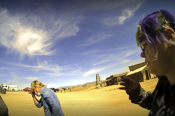In this screen grab from lapel camera video provided by the Santa Fe County Sheriff's Office, movie set armorer Hannah Gutierrez-Reed, right, speaks with a sheriff's deputy as other colleagues, at center and left, react on the set of the western move 