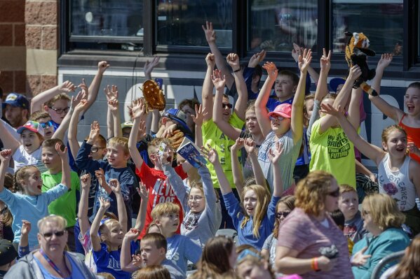 FILE - In this April 11, 2018, file photo, school children cheer as the West Virginia Power face the Lakewood BlueClaws at Appalachian Power Park, in Charleston, W.V. Some towns who have found their minor league teams on a possible Major League Baseball list of 42 teams to eliminate have begun fighting back. (Craig Hudson/Charleston Gazette-Mail via AP, File)