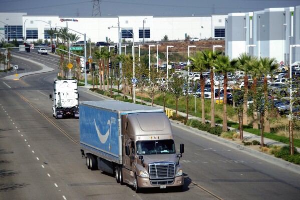 FILE - A semi-truck turns into an Amazon Fulfillment center in Eastvale, Calif. on Thursday, Nov. 12, 2020. An internal Amazon memo has provided a stark look at the company’s carefully laid out plans to grow its influence in Southern California through a plethora of efforts that include burnishing its reputation through charity work and pushing back against “labor agitation” from the Teamsters and other groups. (Watchara Phomicinda/The Orange County Register via AP, File)