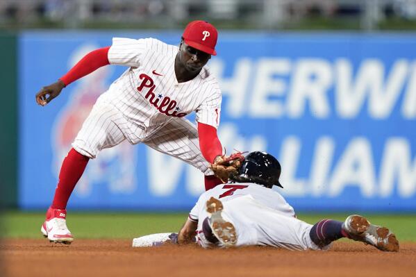 Philadelphia Phillies shortstop Didi Gregorius, left, tags out Atlanta Braves' Dansby Swanson after he tried to steal second during the seventh inning of a baseball game, Tuesday, July 26, 2022, in Philadelphia. (AP Photo/Matt Slocum)