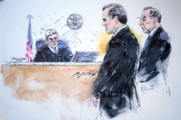 In this courtroom sketch, President Joe Biden's son Hunter Biden, center, appears alongside attorney Abbe Lowell, right, in front of Judge Mark C. Scarsi, left, in federal court, Thursday, Jan. 11, 2024, in Los Angeles. Biden pleaded not guilty Thursday to federal tax charges filed after the collapse of a plea deal that could have spared him the spectacle of a criminal trial during the 2024 campaign. (Bill Robles via AP)