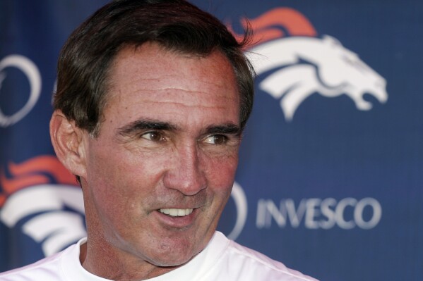 FILE - Denver Broncos head coach Mike Shanahan laughs as he talks to the media following the morning session of football training camp in Denver, Sunday, July 29, 2007. Versatile running back Roger Craig, and two-time Super Bowl-winning coaches Tom Coughlin and Mike Shanahan advanced to the next stage of consideration for the Pro Football Hall of Fame. The selection committees cut down the list of candidates from 31 seniors and 29 coaches and contributors to 12 in each category in results announced Thursday, July 27, 2023. (AP Photo/Jack Dempsey, File)
