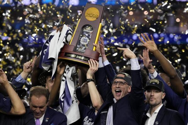 Connecticut head coach Dan Hurley celebrates with the trophy after their win against San Diego State in the men's national championship college basketball game in the NCAA Tournament on Monday, April 3, 2023, in Houston. (AP Photo/David J. Phillip)