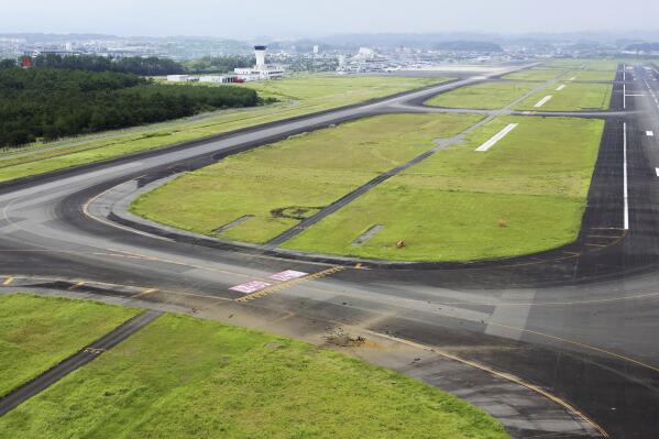 An American bomb from WWII explodes at a Jap airport, leaving a crater at the taxiway