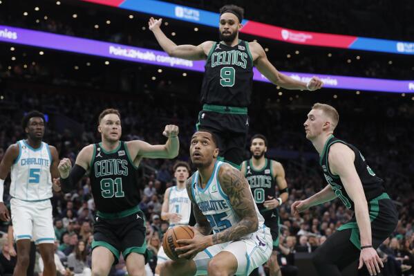 Charlotte Hornets' P.J. Washington (25) looks to shoot as Boston Celtics' Derrick White (9), Blake Griffin (91) and Sam Hauser, right, defend during the first half of an NBA basketball game, Friday, Feb. 10, 2023, in Boston. (AP Photo/Michael Dwyer)