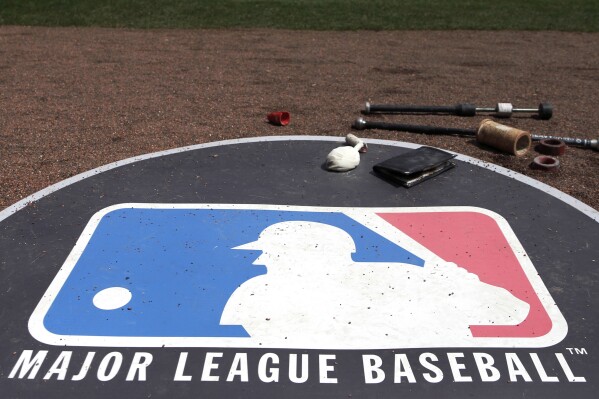 FILE - The Major League Baseball logo serves as the visitor's on-deck circle before a baseball game between the Chicago White Sox and the Cleveland Indians, April 24, 2013, in Chicago. Major League Baseball has canceled plans to play regular-season games in Paris in 2025 after failing to find a promoter, two people familiar with the decision told The Associated Press, Thursday, Nov. 16, 2023. (AP Photo/Charles Rex Arbogast, File)